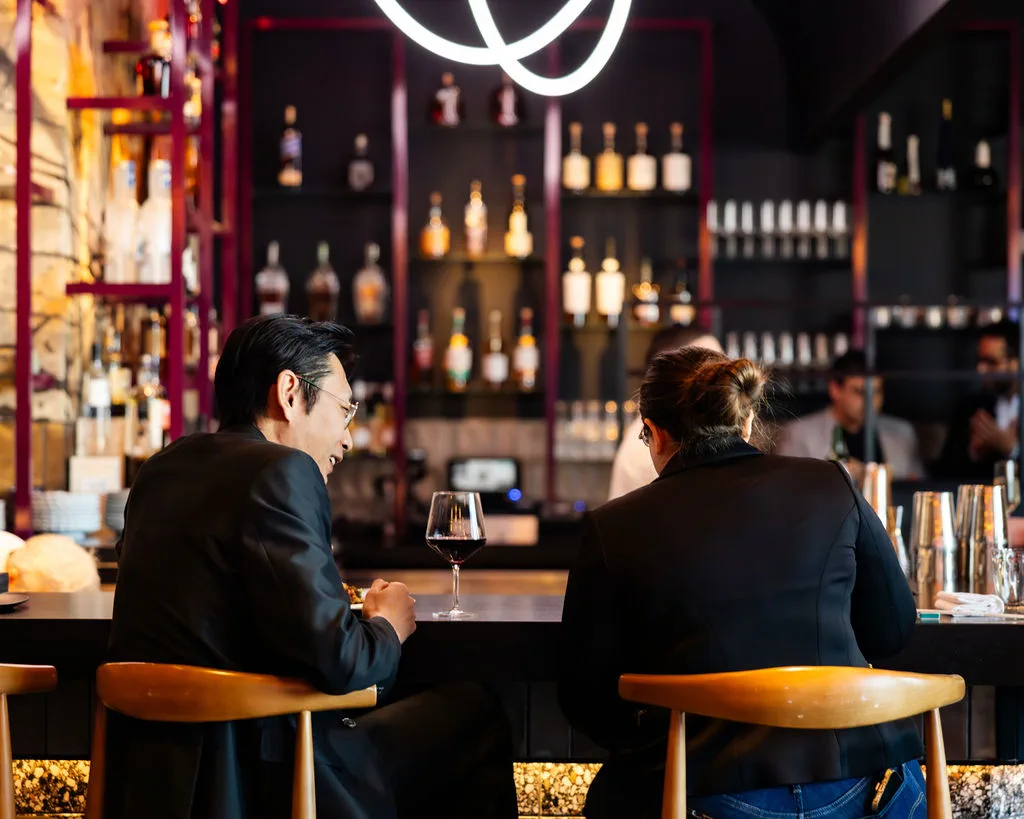 Guests sharing a drink at The Naisho Room bar